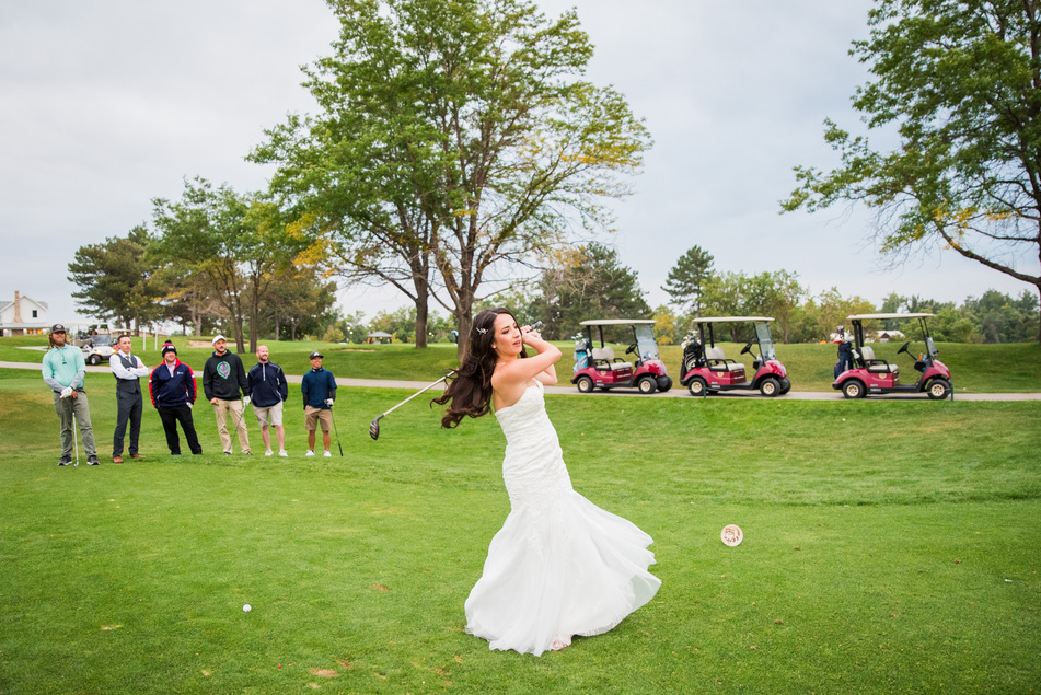 A bride swinging her golf club on the golf course at The Barn at Raccoon Creek.