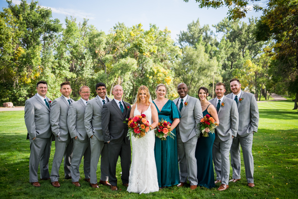 A group of wedding attendants posing for a photo at The Barn at Raccoon Creek in Littleton, Colorado.